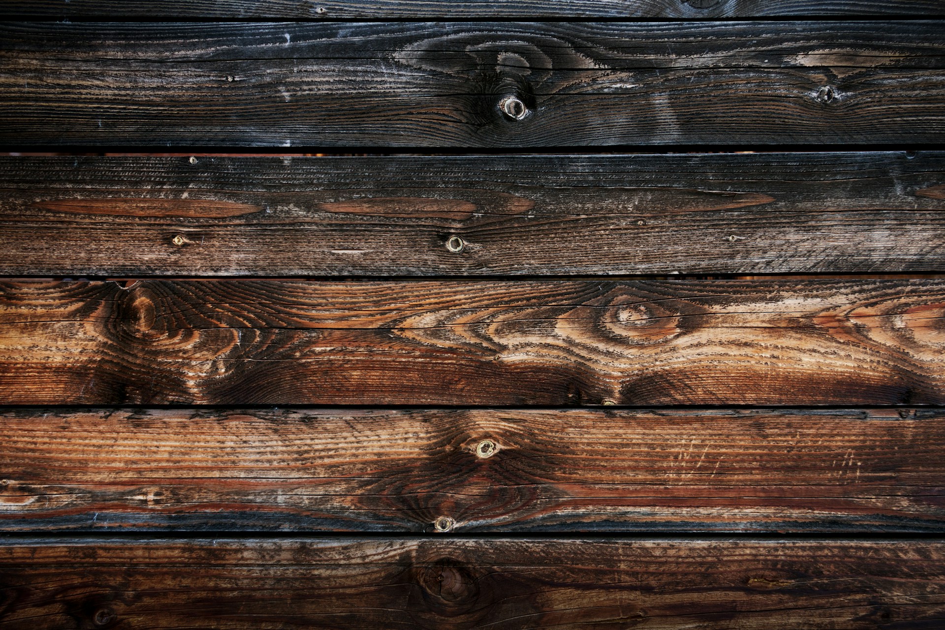 Warm brown timber surface with pronounced natural grain and atmospheric texture
